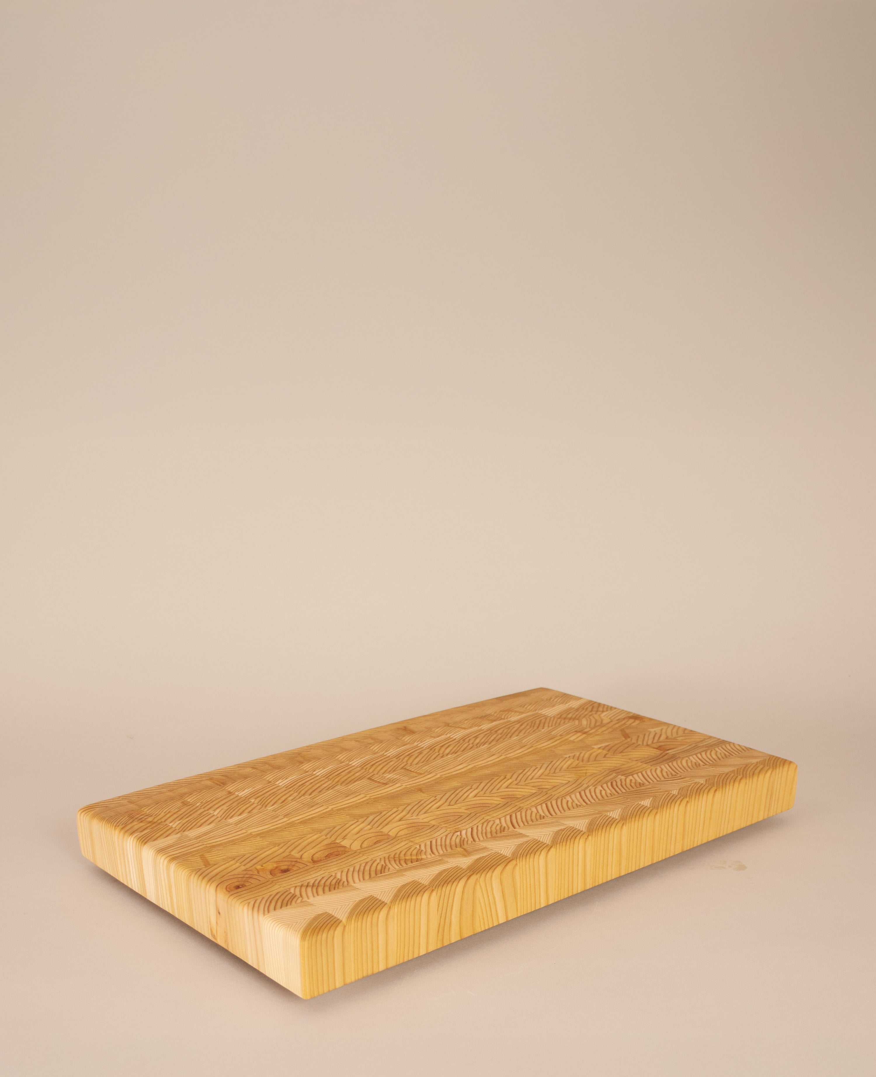 Wooden cutting board on a beige background