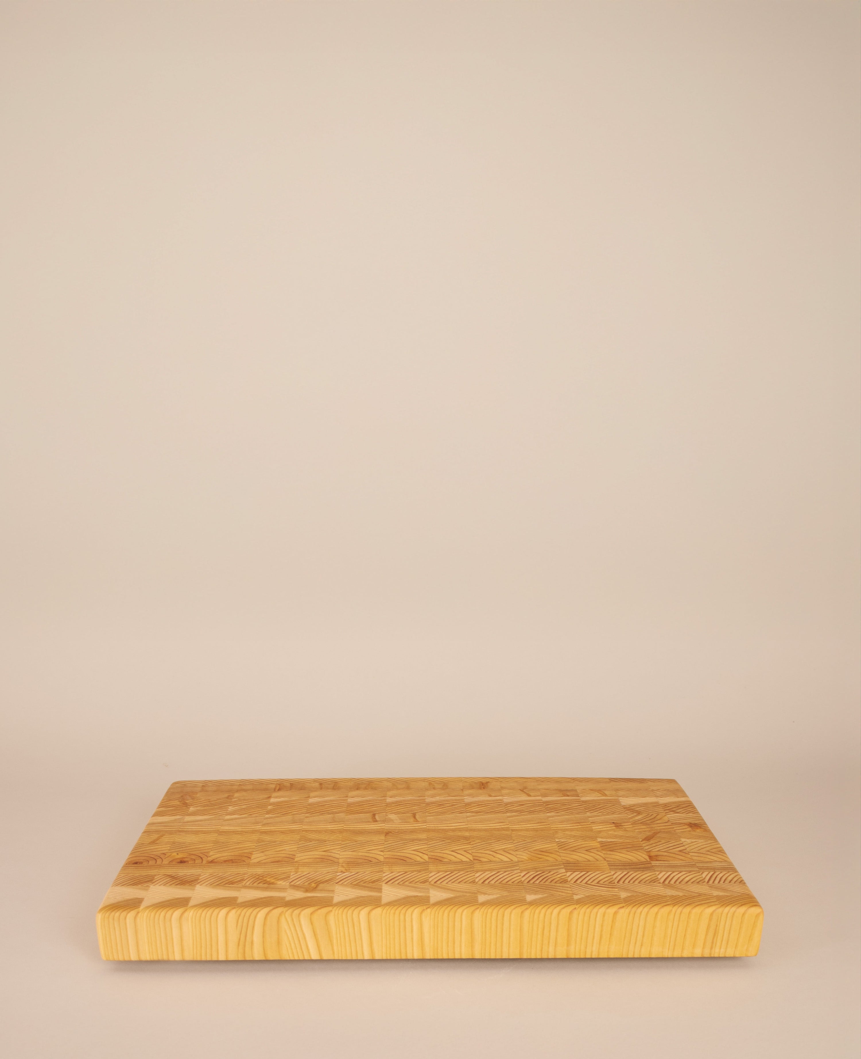 Wooden cutting board on a beige background